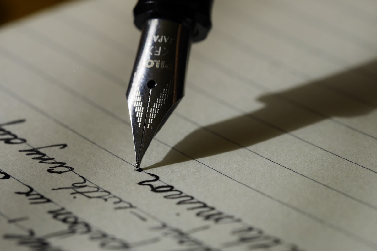 A fountain pen signing a document